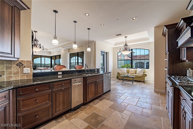 kitchen featuring appliances with stainless steel finishes, decorative light fixtures, sink, and plenty of natural light