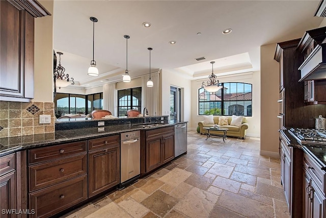 2546 Marquesa Royale Ln Unit 7-302, Naples, FL 34109 - kitchen with a raised ceiling, a sink, healthy amount of natural light, stainless steel dishwasher, and recessed lighting