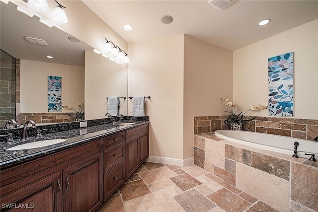 2546 Marquesa Royale Ln Unit 7-302, Naples, FL 34109 - full bath with stone tile flooring, a garden tub, double vanity, baseboards, and recessed lighting