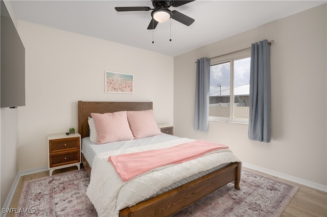 bedroom with hardwood / wood-style floors and ceiling fan