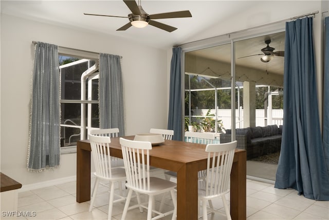 tiled dining room featuring ceiling fan and a healthy amount of sunlight