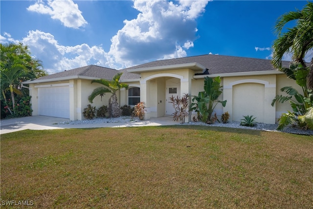 view of front facade with a front lawn and a garage