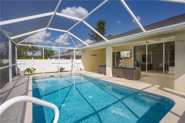 view of swimming pool with a patio area and a lanai