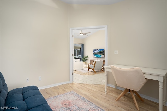 office featuring light hardwood / wood-style flooring, lofted ceiling, and ceiling fan