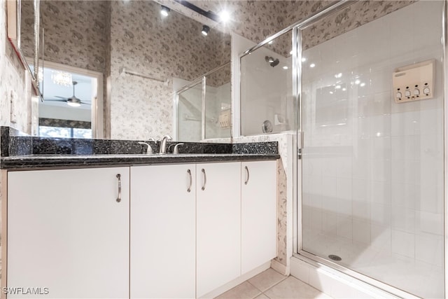 bathroom featuring vanity, ceiling fan, tile patterned flooring, and an enclosed shower