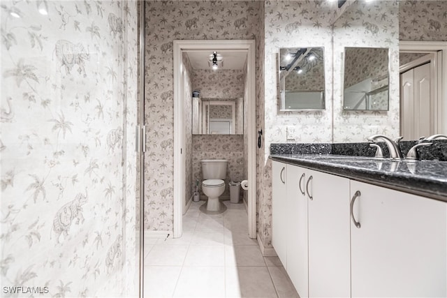 bathroom featuring vanity, toilet, and tile patterned flooring