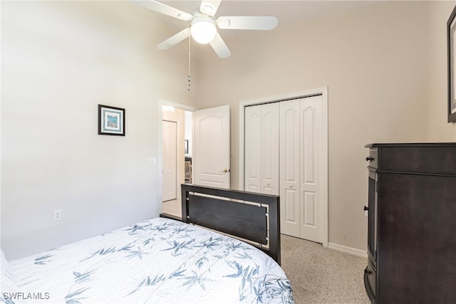 carpeted bedroom featuring ceiling fan and a towering ceiling