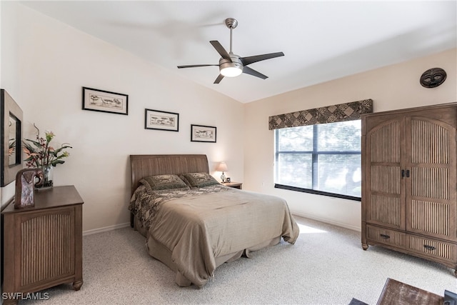 bedroom featuring light carpet, vaulted ceiling, and ceiling fan