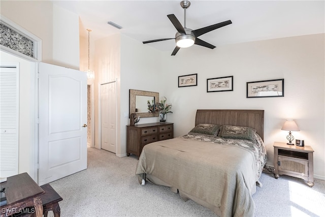 bedroom featuring light colored carpet and ceiling fan