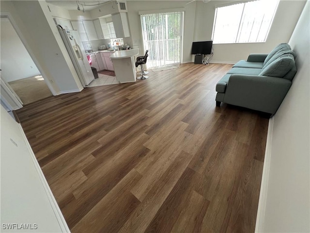 living room with light wood-type flooring and baseboards