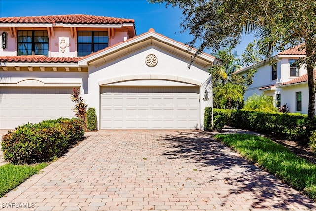 mediterranean / spanish home featuring a garage