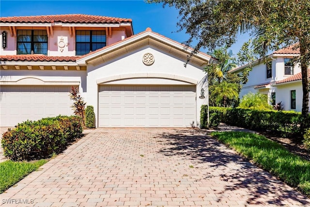 3157 Aviamar Cir Unit 102, Naples, FL 34114 - mediterranean / spanish-style house with stucco siding, decorative driveway, and a tile roof