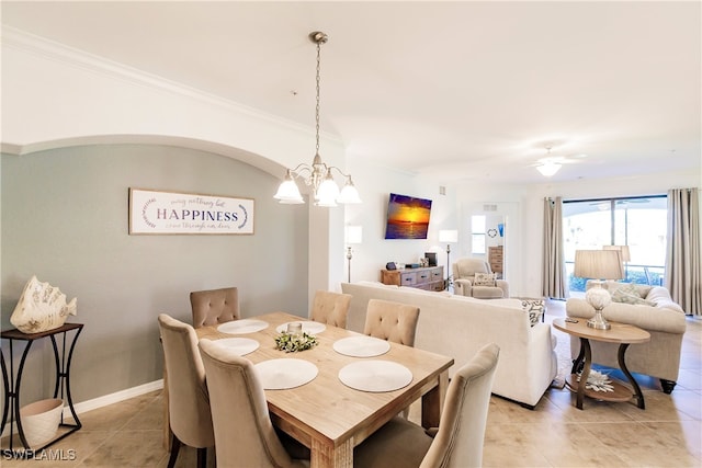 dining room with ornamental molding, light tile patterned floors, and ceiling fan with notable chandelier