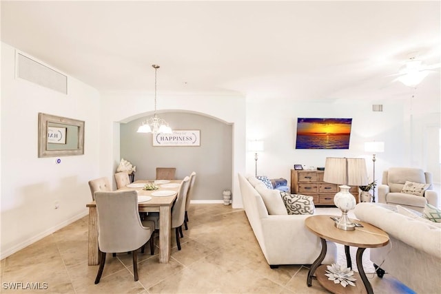 3157 Aviamar Cir Unit 102, Naples, FL 34114 - dining space with a chandelier, light tile patterned floors, baseboards, and a ceiling fan