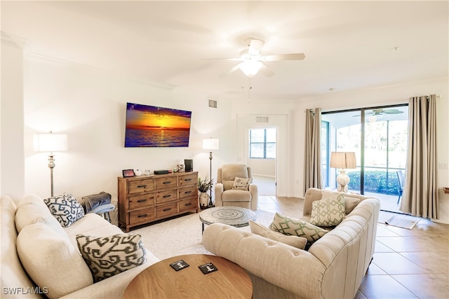 living room featuring ornamental molding, light tile patterned floors, and ceiling fan