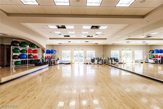 3157 Aviamar Cir Unit 102, Naples, FL 34114 - workout area with a paneled ceiling, plenty of natural light, wood finished floors, and a tray ceiling