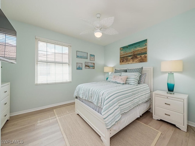 bedroom with light hardwood / wood-style floors and ceiling fan