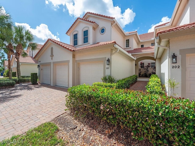 mediterranean / spanish-style home featuring a garage