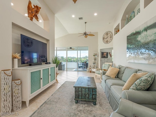 tiled living room with high vaulted ceiling and ceiling fan