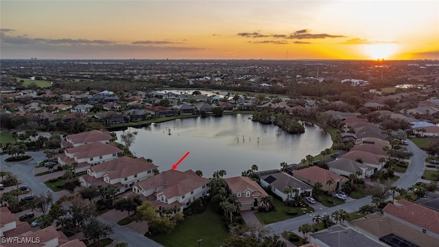 aerial view at dusk with a water view