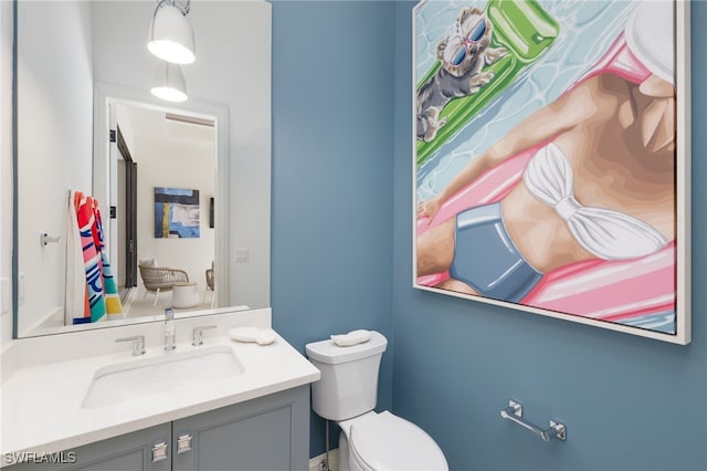 bathroom featuring vanity and toilet