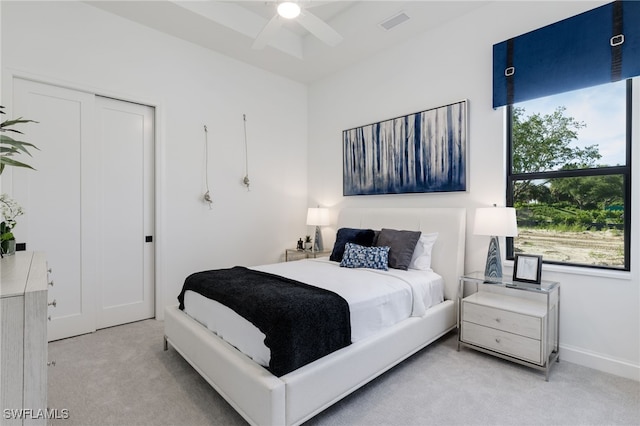 carpeted bedroom with a closet and ceiling fan