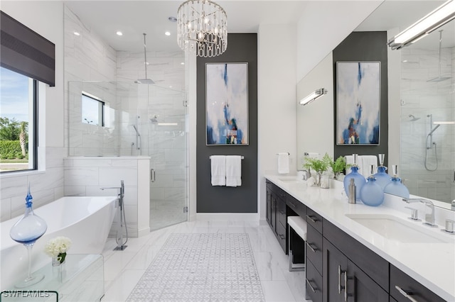 full bathroom with a freestanding bath, a sink, double vanity, a chandelier, and a shower stall