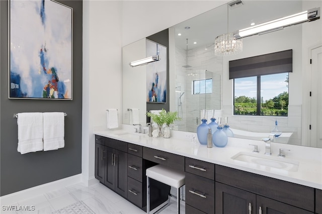 bathroom featuring vanity, shower with separate bathtub, and a notable chandelier