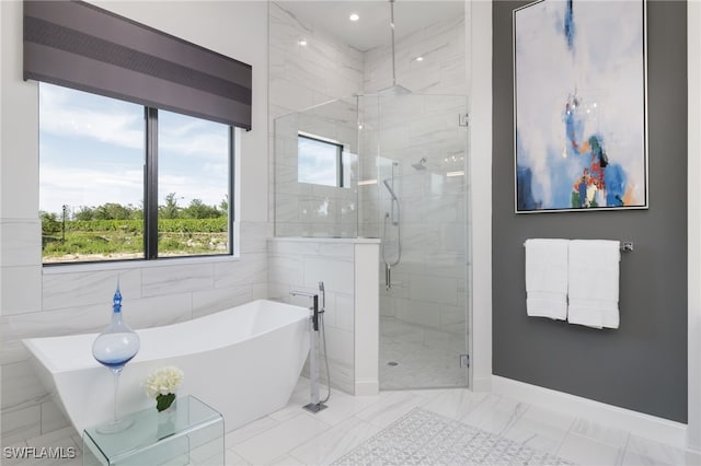 full bathroom featuring marble finish floor, baseboards, recessed lighting, a freestanding bath, and a stall shower
