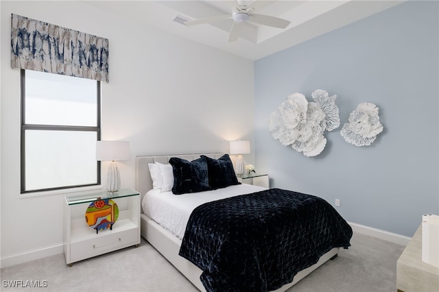 carpeted bedroom with multiple windows and ceiling fan