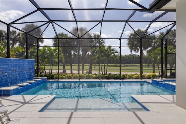 view of pool with a patio area and a lanai