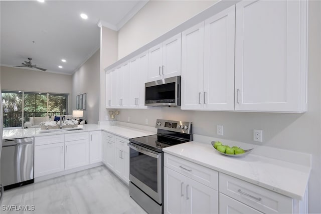 kitchen featuring sink, white cabinetry, ceiling fan, stainless steel appliances, and crown molding