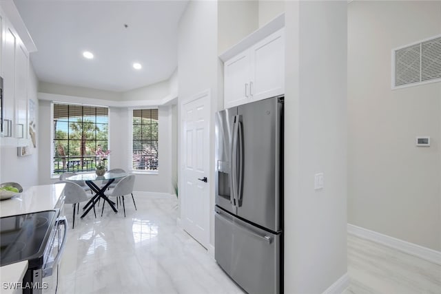 kitchen with white cabinetry and stainless steel appliances