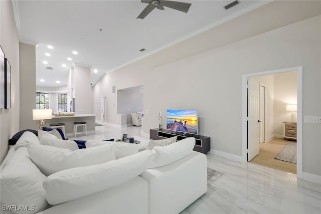 living room featuring ornamental molding and ceiling fan