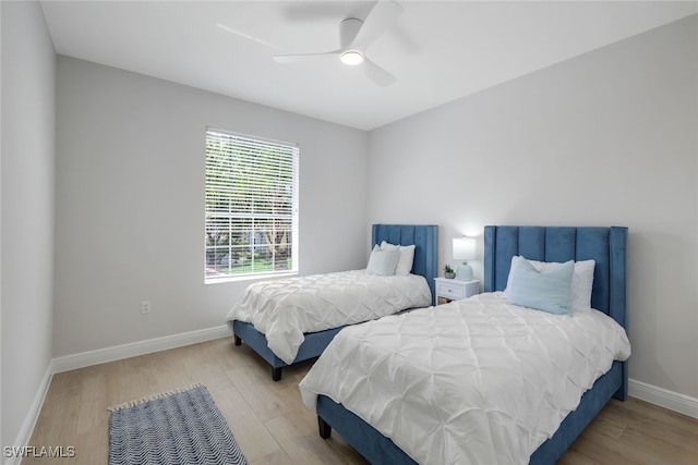 bedroom with light hardwood / wood-style flooring and ceiling fan