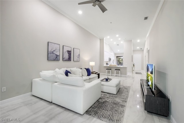 living room with crown molding and ceiling fan