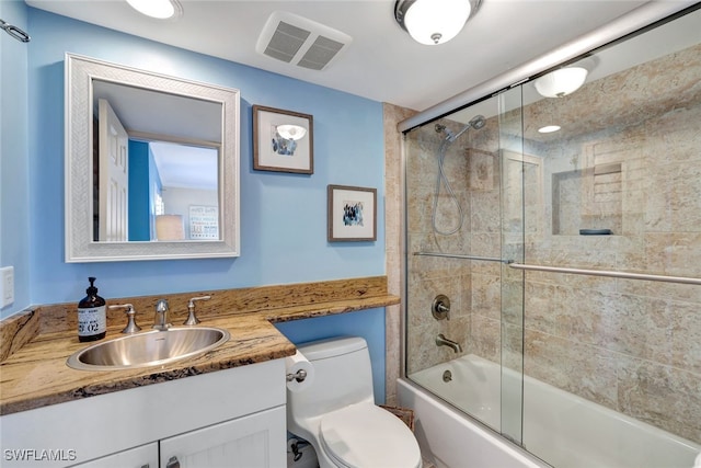 full bathroom featuring vanity, toilet, and enclosed tub / shower combo