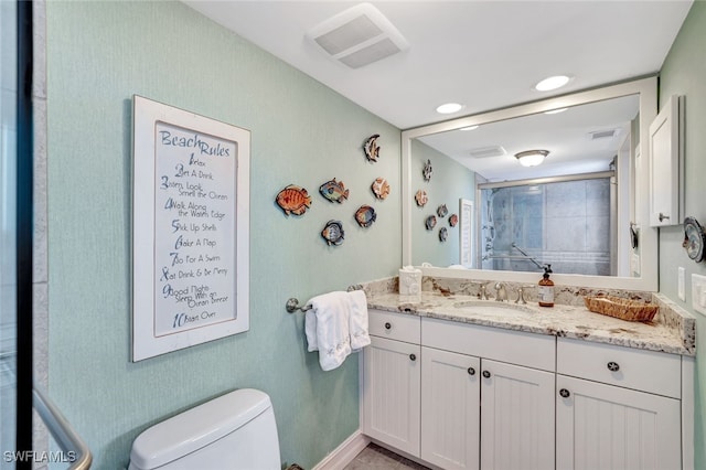 bathroom featuring vanity and toilet