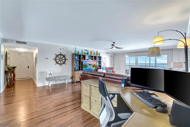 office space featuring hardwood / wood-style floors, ceiling fan, and ornamental molding