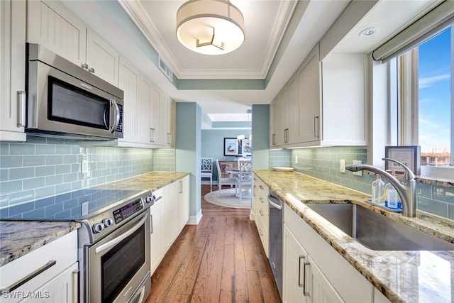 kitchen with sink, stainless steel appliances, tasteful backsplash, dark hardwood / wood-style floors, and crown molding