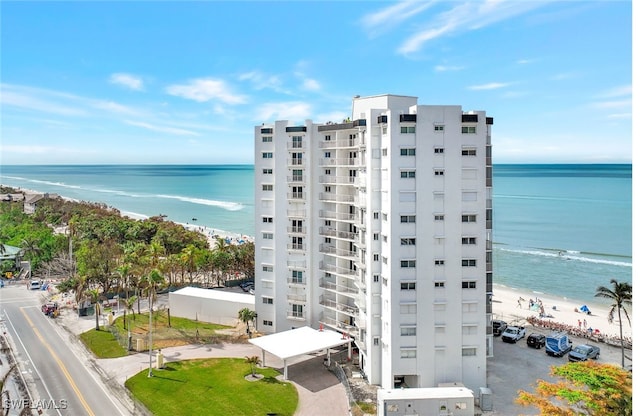 exterior space with a water view and a view of the beach