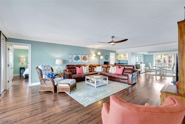 living room featuring hardwood / wood-style flooring, ceiling fan, and ornamental molding