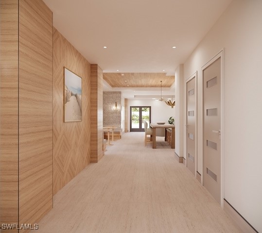 hall with french doors, wood-type flooring, and an inviting chandelier