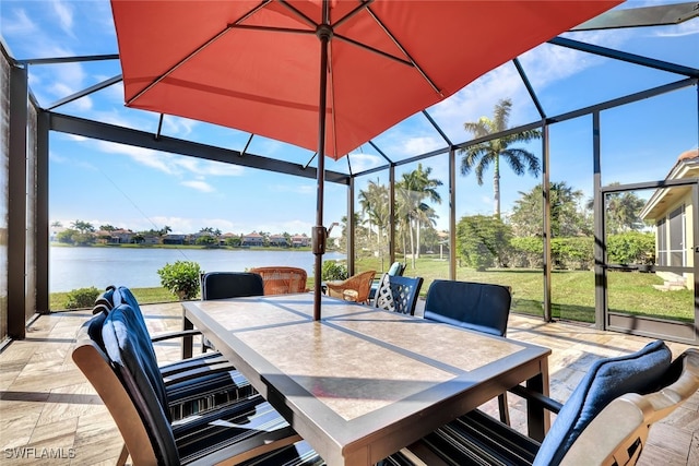 view of patio featuring a lanai and a water view