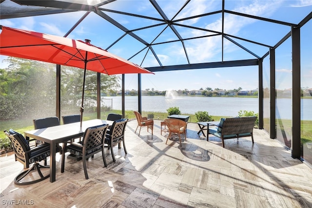 view of patio / terrace featuring glass enclosure and a water view