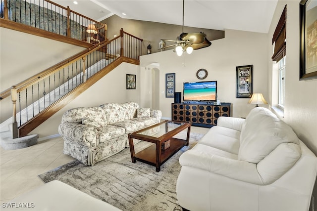 living room featuring light tile patterned floors, high vaulted ceiling, and ceiling fan