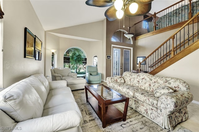 living room with french doors, vaulted ceiling, ceiling fan, and light tile patterned flooring