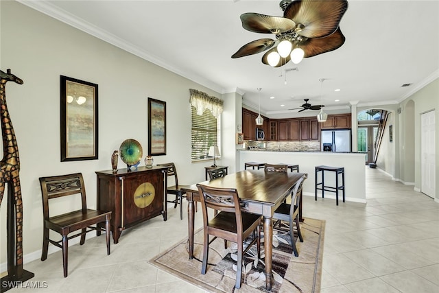 dining area with ceiling fan, ornamental molding, and light tile patterned floors