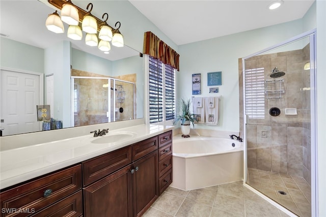 bathroom with shower with separate bathtub, vanity, and tile patterned floors