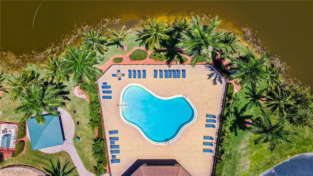 view of pool with a water view and a patio